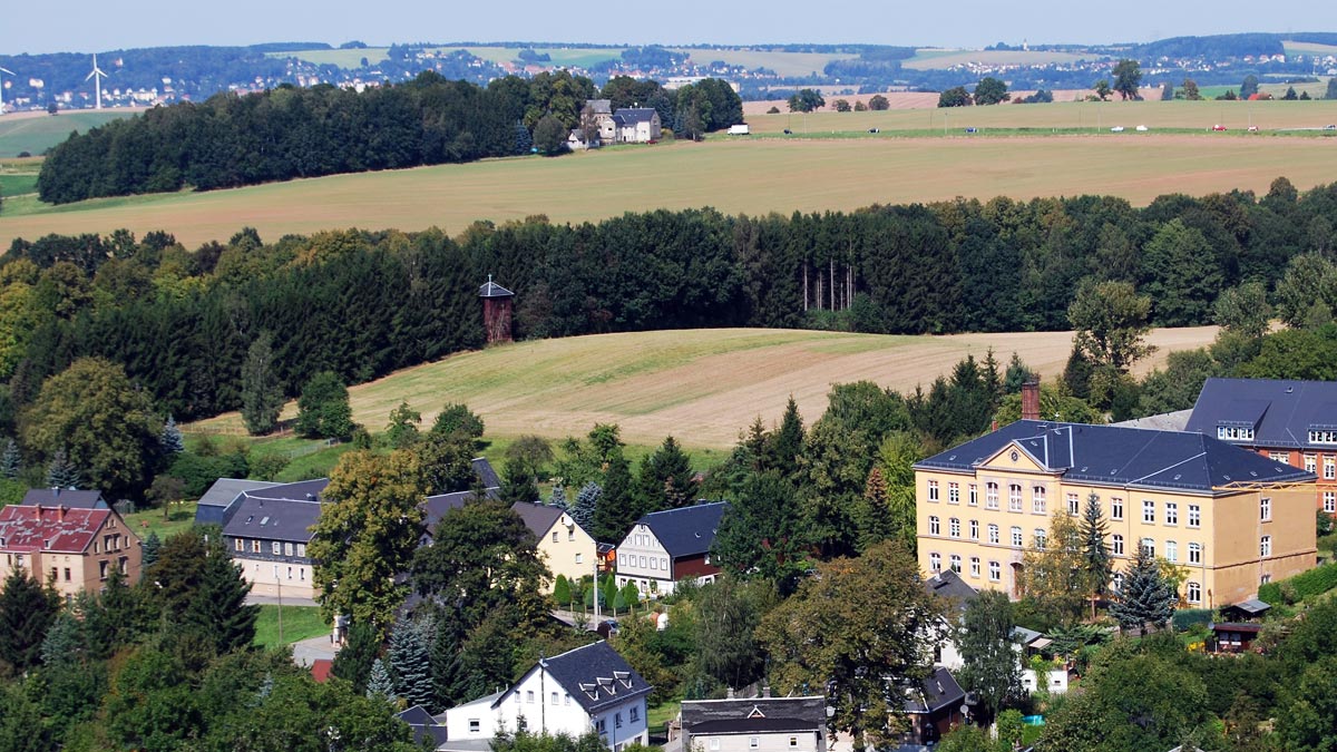 Blick auf den neuen Glockenturm mit Feld, Grundschule und Häusern im Vordergrund | Bildquelle: Sven Schimmel